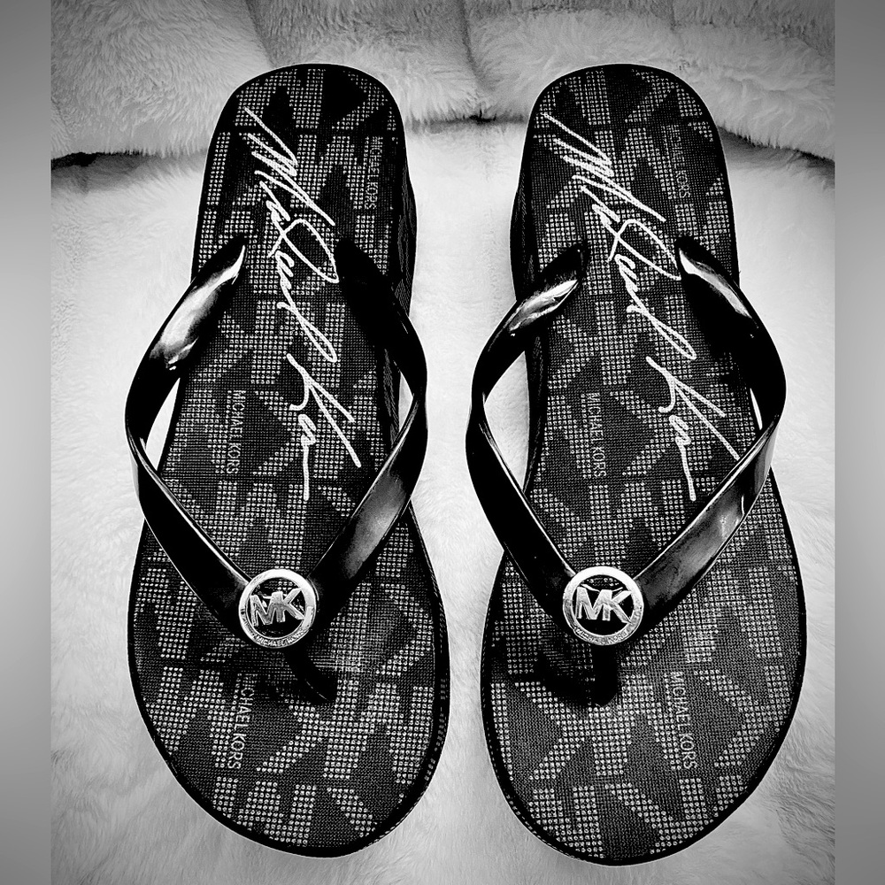 Designer Michael Kors black wedge flip flop. Size 7